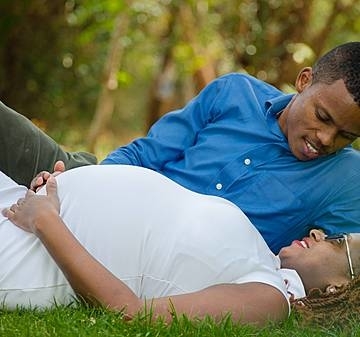 Category pregnant woman lying beside man in grass ground 2146911